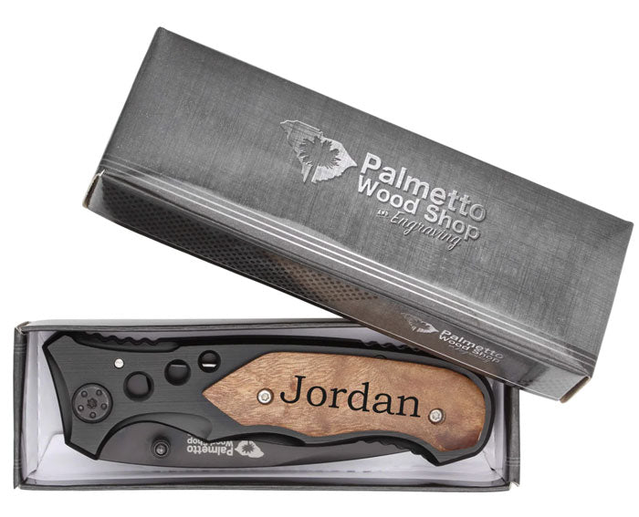 black engraved pocket knife in a box