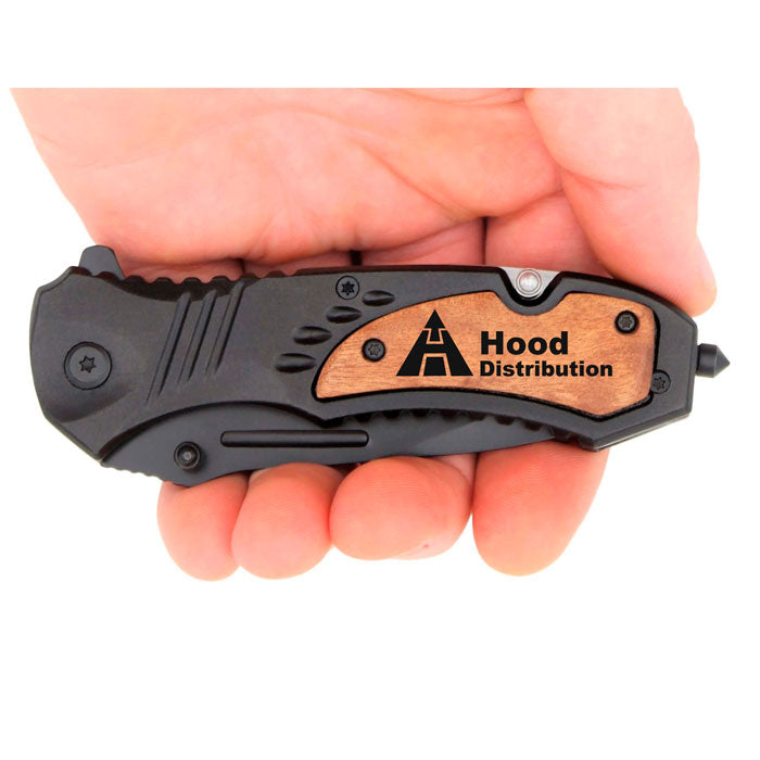 a man holding an engraved smith and wesson pocket knife