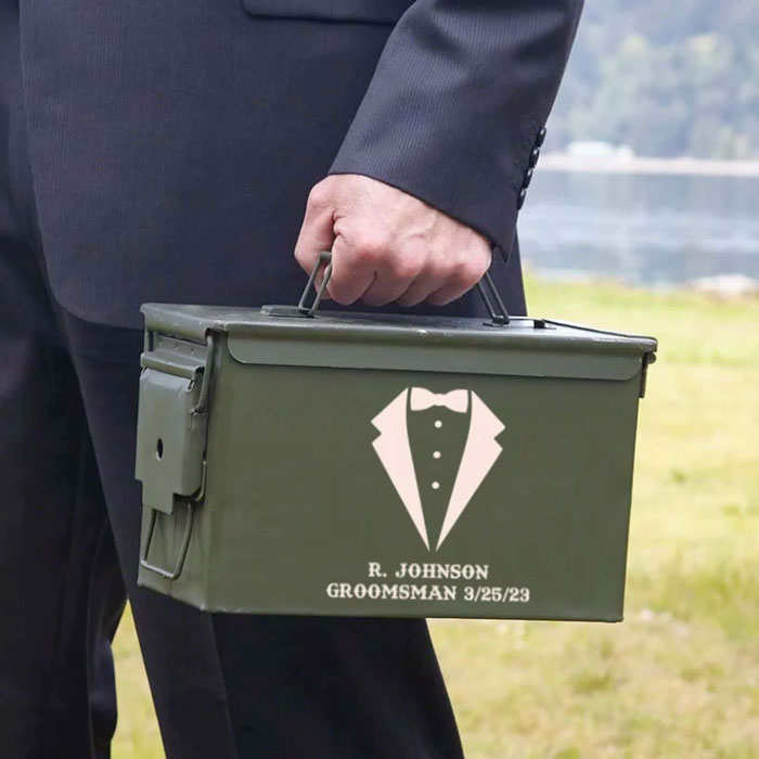 groomsman in a tux carrying personalized ammo can
