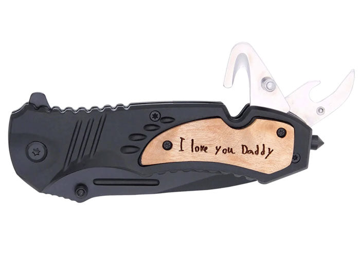 handwriting engraved on a matte black pocket knife