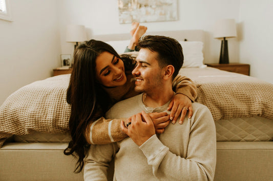 A couple smiling romantically at each other