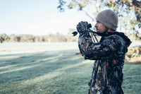 A hunter holding binoculars