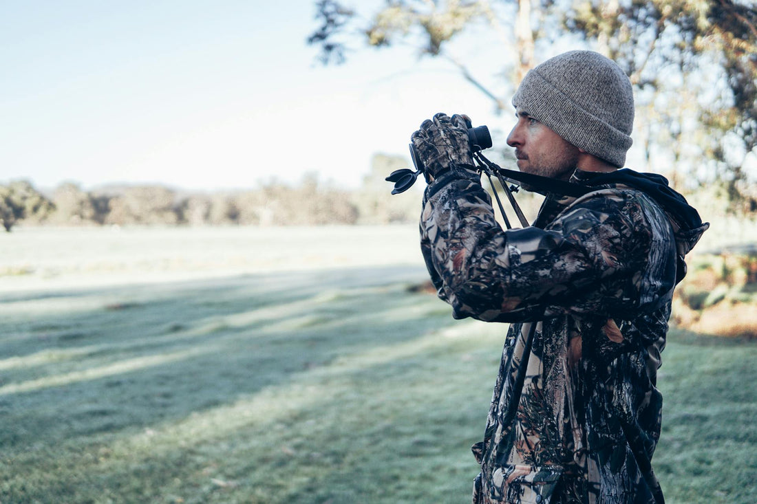 A hunter holding binoculars
