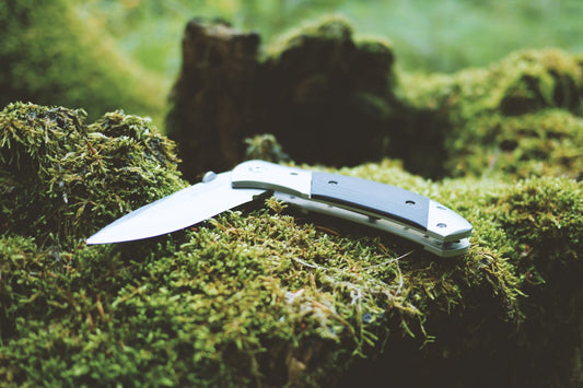 A pocket knife on moss