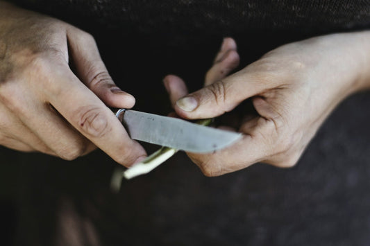 man sharpening a pocket knife