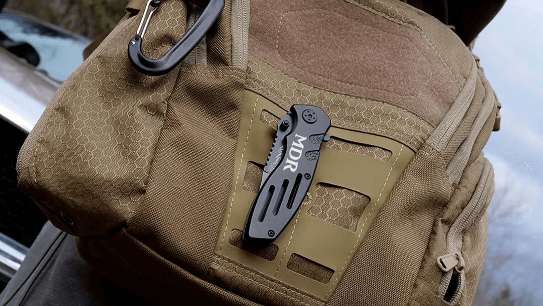 smith and wesson extreme ops engraved pocket knife on a backpack