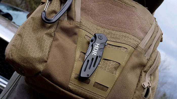 black smith and wesson extreme ops knife on am army green backpack