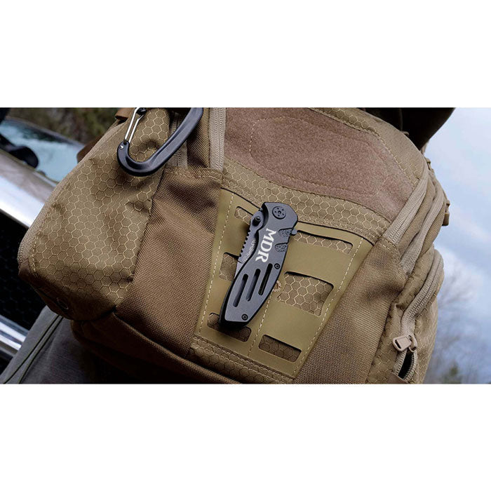 engraved smith and wesson extreme ops pocket knife on a backpack